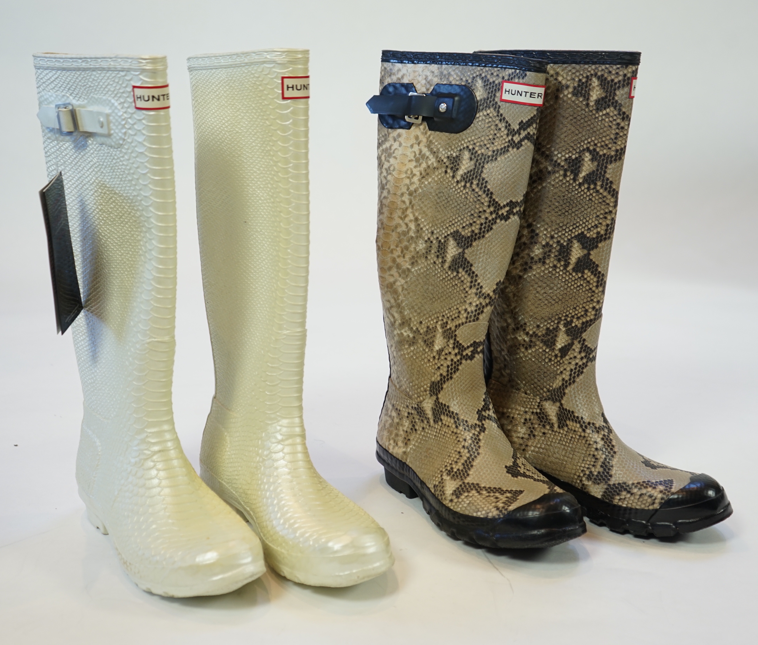 Two pairs of lady's Hunter snake-skin effect wellington boots, size UK 7